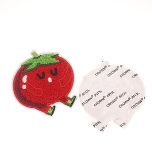 Puede incluir: Parche de tomate rojo bordado con una cara linda. El parche tiene un respaldo adhesivo blanco.