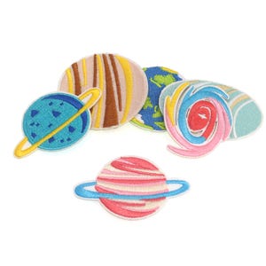 May include: A set of six colorful embroidered iron-on patches featuring planets and a swirling galaxy. The patches are perfect for adding a whimsical touch to clothing, bags, or other fabric items.