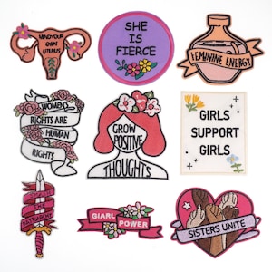 May include: Set of 10 embroidered iron-on patches with feminist themes. The patches feature phrases like "She is Fierce", "Grow Positive Thoughts", "Smash the Patriarchy", and "Girl Power".
