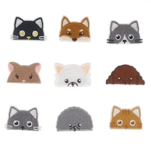 May include: Set of nine embroidered iron-on patches featuring various animal designs. The patches include a black cat, a brown fox, a gray cat, a brown hamster, a white dog, a brown dog, a gray hedgehog, a gray cat, and an orange cat.