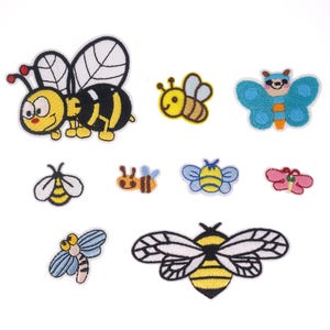 May include: A set of nine embroidered iron-on patches featuring various bee and butterfly designs. The patches are colorful and feature yellow, black, blue, red, and white colors.