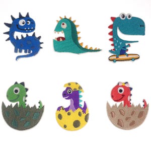 May include: A collection of six colorful dinosaur patches. The patches feature various designs, including a blue dinosaur with spikes, a green dinosaur with an open mouth, and a blue dinosaur riding a skateboard. Other patches show dinosaurs hatching from eggs.
