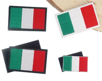 May include: Rectangular patches featuring the Italian flag design. Each patch has a green, white, and red vertical stripe pattern. The patches are made of fabric and have a black backing. The patches vary in size.