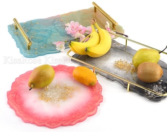 May include: Three resin serving trays with gold accents and a variety of fruit on top. The trays are in shades of blue, gray, and pink.