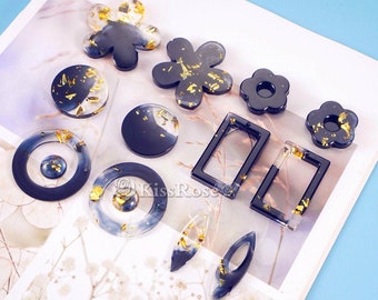 May include: Assortment of black resin earring blanks with gold leaf accents. The shapes include circles, ovals, rectangles, and flowers.