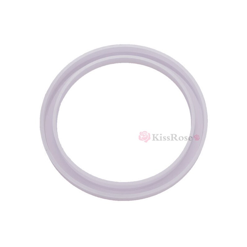 May include: A white silicone ring with a smooth, rounded surface. The ring has a double lip design.