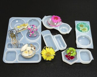 May include: A set of clear silicone molds for resin crafts. The molds are shaped like circles, ovals, and rectangles. The molds are filled with colorful resin and dried flowers.