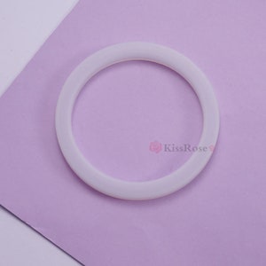 May include: A white silicone ring, likely used for a coffee maker or other kitchen appliance.