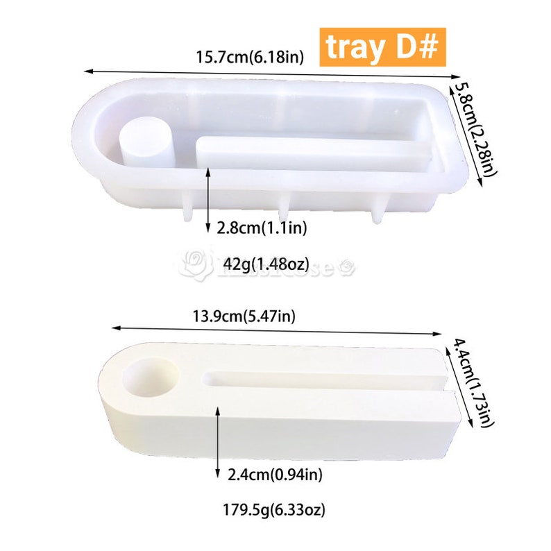 May include: Two white silicone molds for making resin crafts. The larger mold is 15.7 cm long, 5.8 cm wide, and 2.8 cm tall. The smaller mold is 13.9 cm long, 4.4 cm wide, and 2.4 cm tall. Both molds have a rectangular shape with a circular indentation on one end.