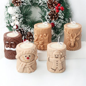 May include: Four Christmas-themed candles in the shape of a tree trunk. The candles feature a snowman, a gingerbread man, a reindeer, and Santa Claus. Each candle has a white wick and a "Smile" label.
