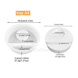 May include: Two white silicone molds for making resin crafts. The larger mold is 9.5 inches in diameter and has a 4.2 inch diameter circle in the center. The smaller mold is 10.6 inches in diameter and has a 4.1 inch diameter circle in the center. Both molds have a small rectangular section on the side.