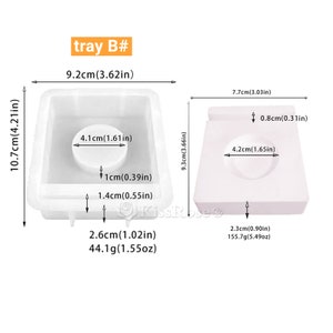 May include: Two white silicone molds for making soap or resin crafts. The mold on the left is a square with a round indentation in the center. The mold on the right is a square with a round indentation in the center. The mold on the left is 9.2 cm wide, 10.7 cm tall, and 2.6 cm deep. The mold on the right is 7.7 cm wide, 9.3 cm tall, and 2.3 cm deep.