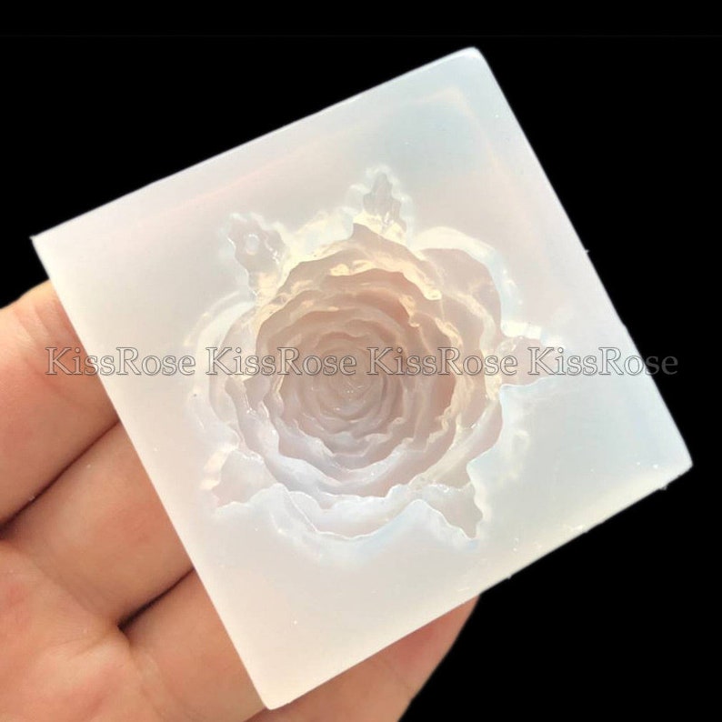 May include: A clear silicone mold shaped like a rose. The mold is designed to create a 3D rose shape.