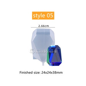 May include: A clear silicone mold for making a large, faceted gemstone. The mold is 2.66 inches tall and the finished gemstone will be 24x24x38 millimeters. The mold is shown with a finished gemstone that is blue, green, and purple.