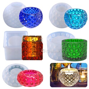 May include: Set of silicone molds for making candle holders. The molds are in the shape of a sphere, a cube, and a cylinder. The molds are shown with finished candle holders in blue, green, red, and orange.