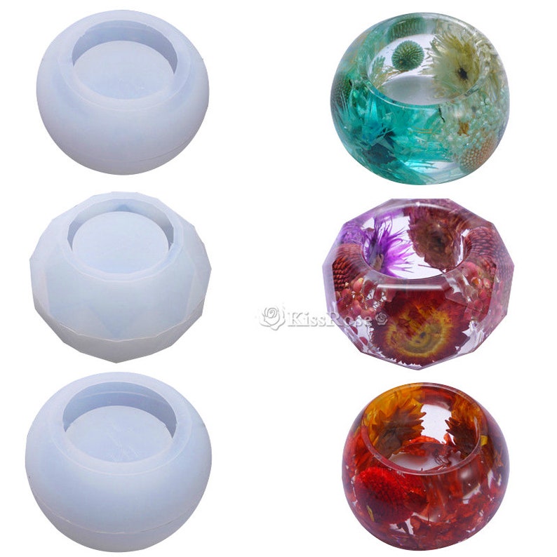 May include: Three silicone molds for resin casting, shown next to three finished resin rings with dried flowers embedded inside. The rings are in shades of green, purple, and red.