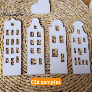 May include: Four white wooden houses with cut-out windows, each measuring 3.7 inches tall and 0.7 inches thick. The houses are arranged in a row on a woven straw mat. The text "02# samples" is printed below the houses.