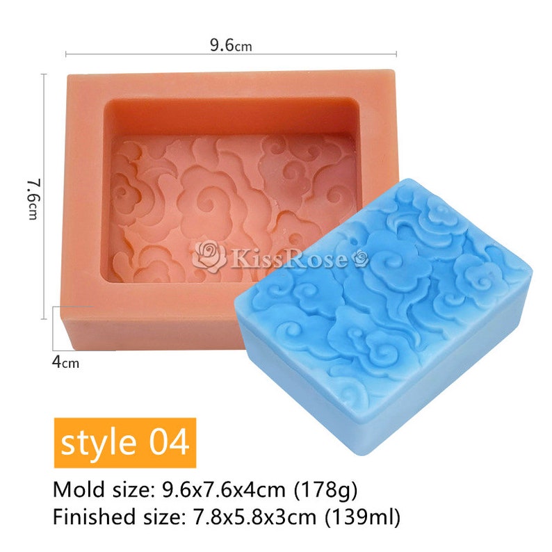 May include: A pink silicone mold with a cloud and floral design. The mold is 9.6 inches long, 7.6 inches wide, and 4 inches tall. A blue soap bar with the same design is shown next to the mold.