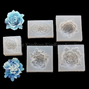 May include: Six silicone molds for making flower-shaped decorations. The molds are white and feature different designs of roses and peonies. The molds are shown next to two finished flower decorations, one blue rose and one blue peony.
