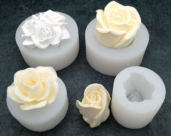 May include: Four white silicone molds for making rose-shaped decorations. The molds are filled with white roses, showing the detail of the mold.