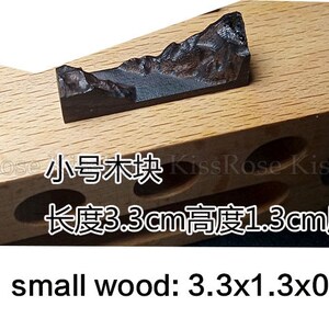 May include: A small wooden block with a dark brown wood grain finish. The block is 3.3 inches long, 1.3 inches high, and 0.8 inches thick. The text "small wood: 3.3x1.3x0.8cm" is printed below the block.