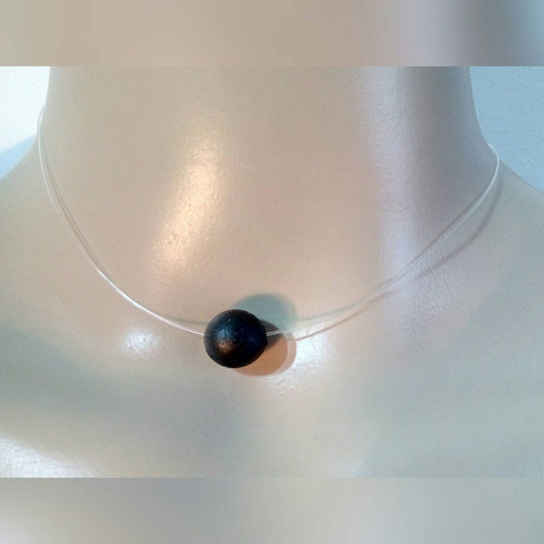 measures 36cm. A Choker necklace made of transparent nylon thread and a beautiful pendant bead black amber scented handmade