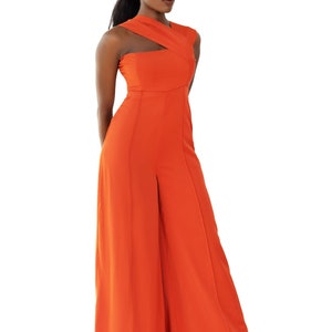 Model wearing Onika Orange Jumpsuit with asymmetrical neckline