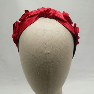 Red satin headband, with fabric flowers and ruched detail. Scrunchie headband lined in floral print.