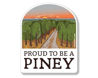 May include: A sticker with a sunset scene of a dirt road through a pine forest. The text "Proud to be a Piney" is below the image.