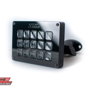 May include: Black rectangular button box with 16 buttons and the text "KGL" on the top. The box is mounted on a black bracket.