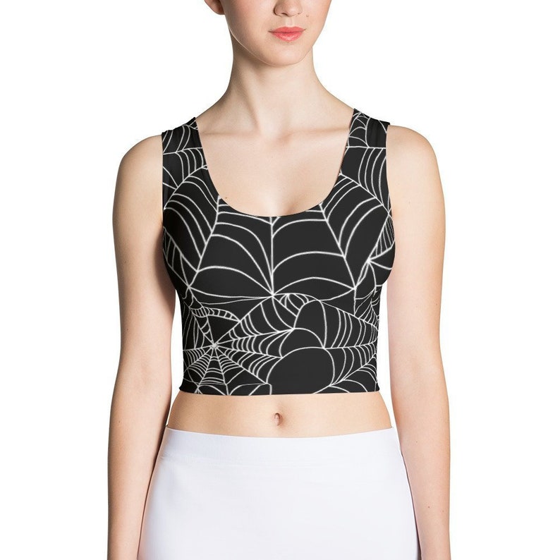 May include: Black crop top with a white spiderweb pattern.
