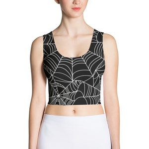 May include: Black crop top with a white spiderweb pattern.