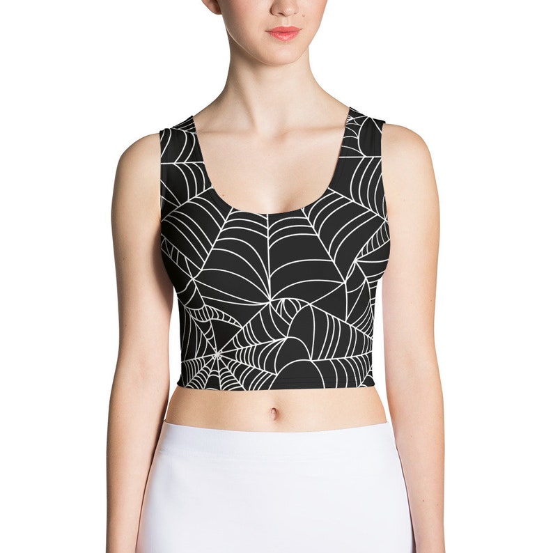 May include: Black crop top with a white spiderweb pattern.