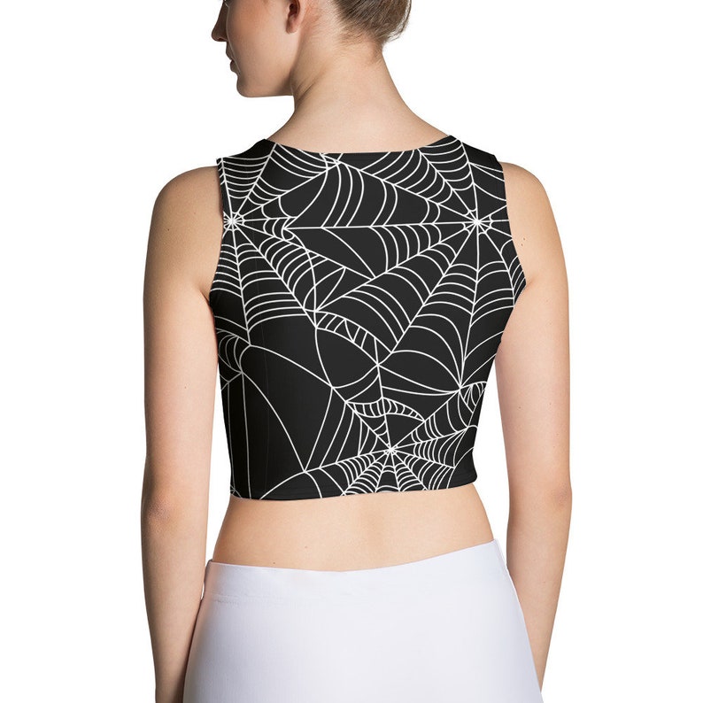 May include: Black crop top with a white spiderweb pattern.