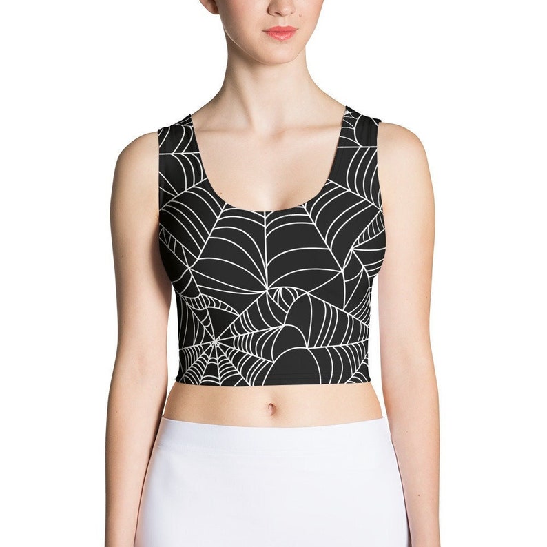 May include: Black crop top with a white spiderweb pattern.