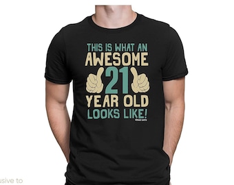 May include: Black t-shirt with a graphic design that says "This is what an awesome 21 year old looks like!" with two thumbs up on either side of the number 21.