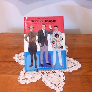 May include: A rustic wooden sign with the text "Welcome to our home" in white lettering. The sign features a distressed finish and a simple, inviting design, perfect for a front porch or entryway.