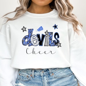 May include: White sweatshirt with the word "Devils" in blue and black leopard print, with the word "Cheer" in black script. Blue stars and a blue megaphone graphic are also featured on the sweatshirt.