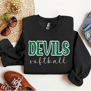May include: Black sweatshirt with the text "DEVILS softball" in green and white lettering.