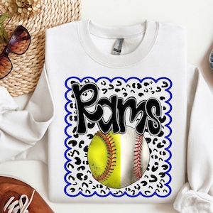 May include: White sweatshirt with a blue and black graphic of a softball and the word "Rams" in a leopard print pattern.