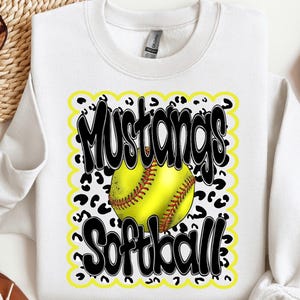 May include: White sweatshirt with a black and yellow graphic design. The graphic features a softball, the words "Mustangs Softball" and a leopard print pattern.