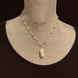 May include: A white baroque pearl pendant necklace with a silver chain and colorful beads.  More pendants are available.