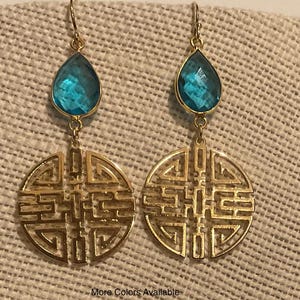 May include: Gold earrings with a blue teardrop-shaped stone and a circular design with intricate details.  More Colors Available.