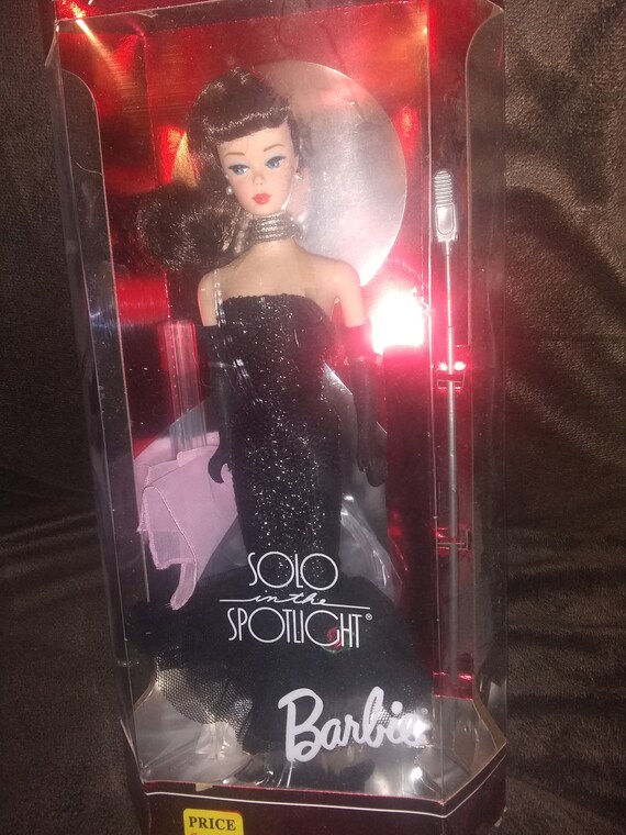 doll stands spotlight