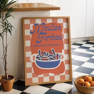 May include: A framed print with a red and white checkered background. The print features a blue and white illustration of a pot of mussels with the text "Moules Frites - délice de fruits de mer -" in blue and white.