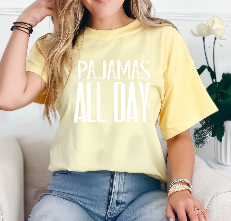 a woman sitting on a couch wearing a yellow shirt