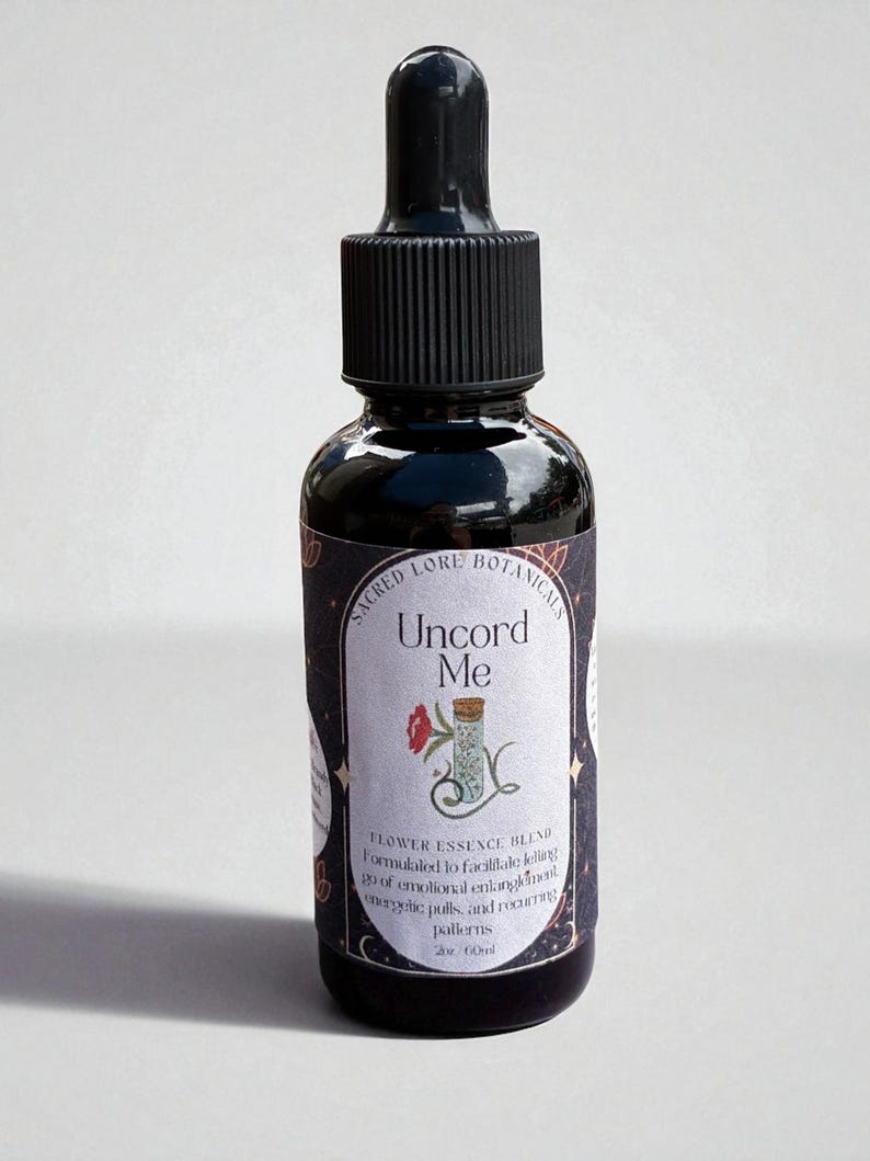 May include: A dark glass bottle with a black dropper and a label that reads "Uncord Me." The label also says "Flower Essence Blend" and "Sacred Lore Botanicals." The bottle contains 2 fl oz (60ml).