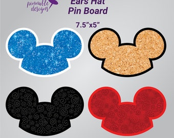May include: Four different styles of cork pin boards shaped like Mickey Mouse ears. The boards are 7.5 inches by 5 inches. The boards are blue with white glitter, brown cork, black with a black and white pattern, and red with a red and white pattern.