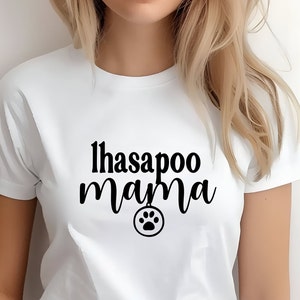 May include: White t-shirt with black text that reads "lhasapoo mama" and a black paw print icon.