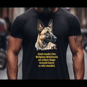 May include: A black t-shirt with a graphic of a Belgian Malinois dog. The text "God made the Belgian Malinois so other dogs would have a role model." is printed in yellow on the shirt.